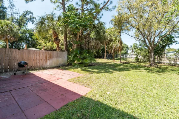 a backyard of a house with yard and trampoline