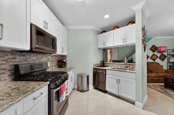 a kitchen with stainless steel appliances granite countertop a stove and a sink