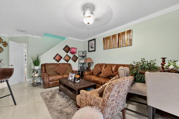 a living room with furniture and a potted plant