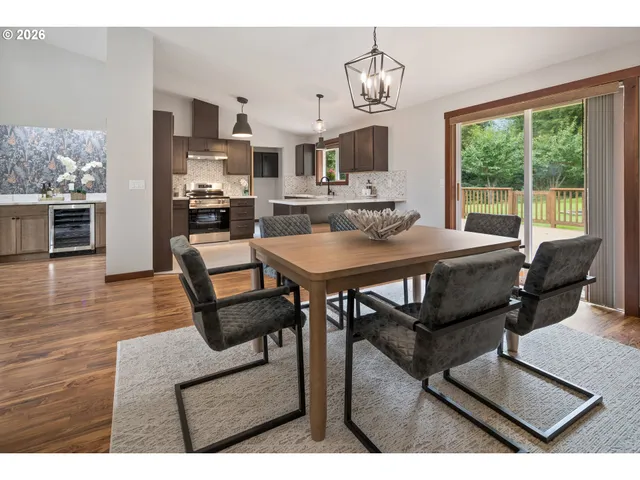 a view of a dining room with furniture wooden floor and a chandelier