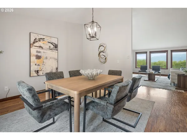 a kitchen with stainless steel appliances a stove a sink dishwasher and a refrigerator with wooden floor