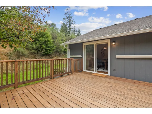 a view of backyard with deck and seating space