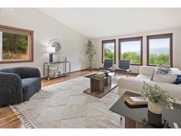 a living room with furniture and a wooden floor