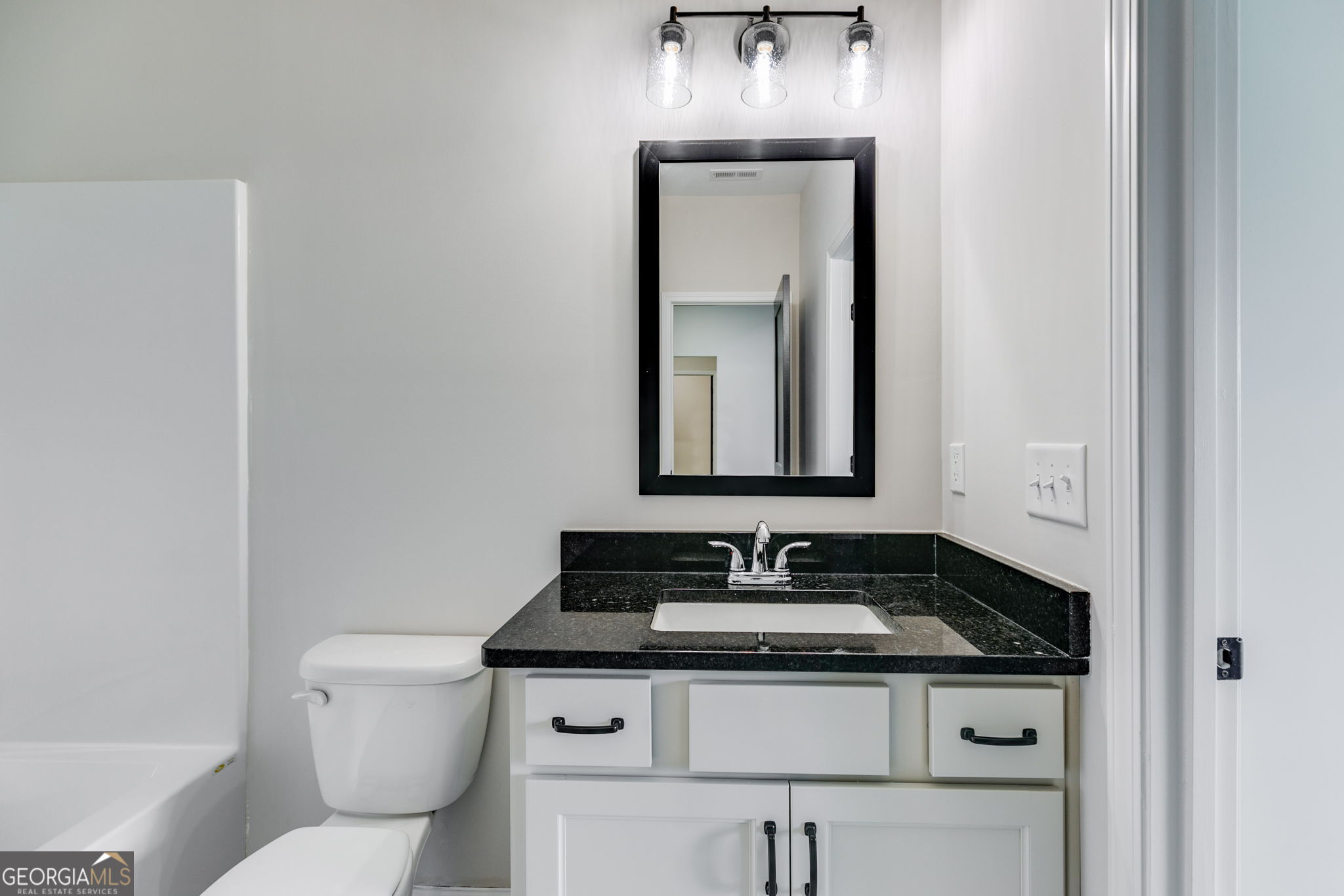 10 Avery Road Roopville, GA 30170 - Photo 12 of 46 a bathroom with a toilet sink and mirror