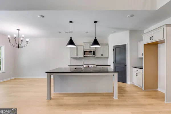 a kitchen with stainless steel appliances granite countertop a sink and a refrigerator