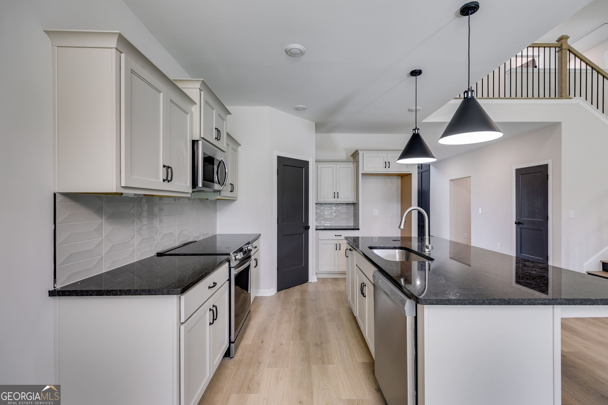 10 Avery Road Roopville, GA 30170 - Photo 18 of 46 a kitchen with stainless steel appliances granite countertop a sink a stove and a refrigerator