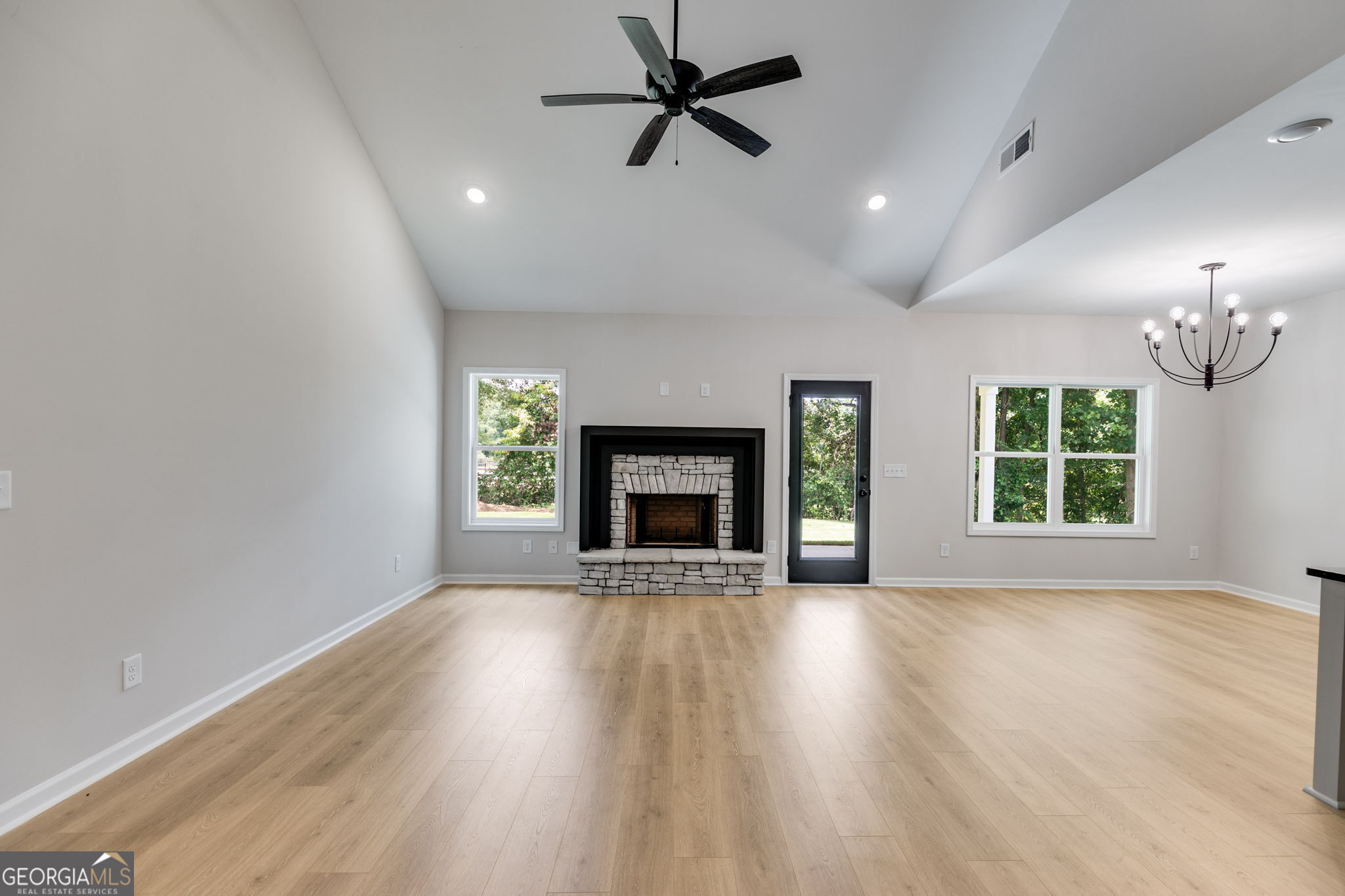10 Avery Road Roopville, GA 30170 - Photo 21 of 46 an empty room with windows fireplace and a kitchen view