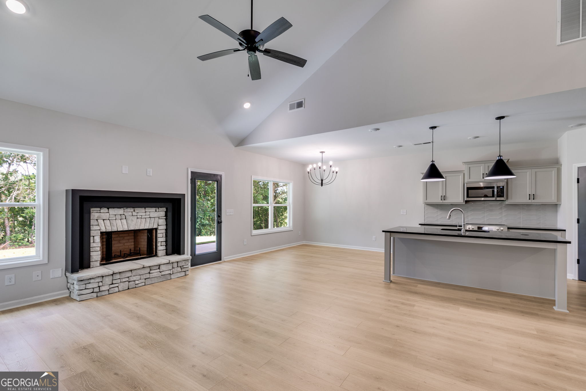 10 Avery Road Roopville, GA 30170 - Photo 22 of 46 an empty room with wooden floor a fireplace and windows