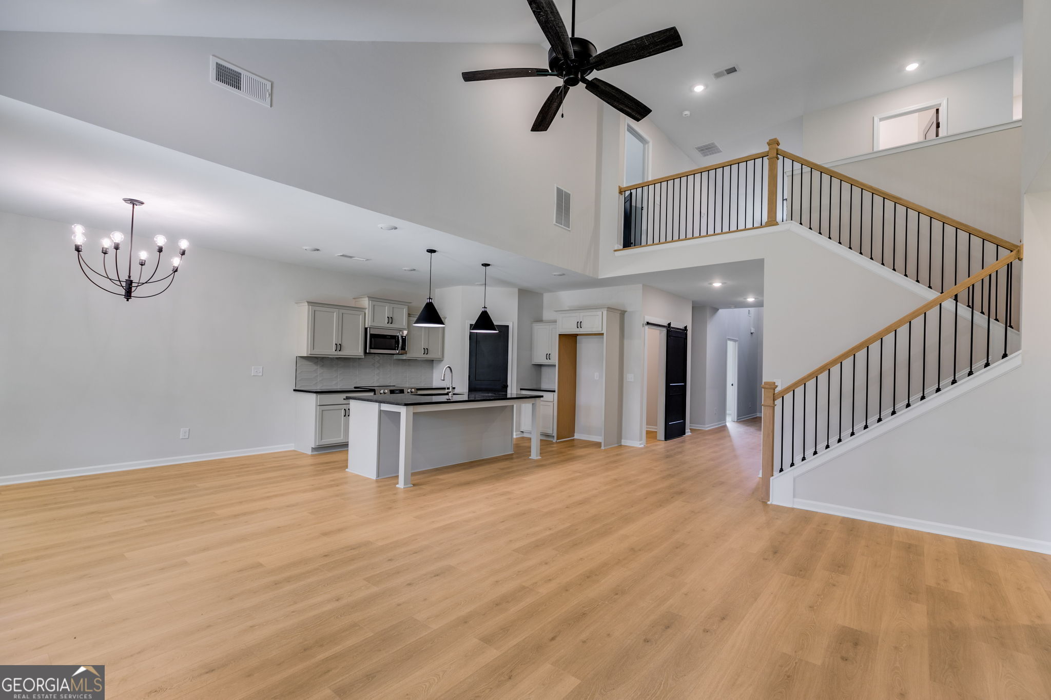 10 Avery Road Roopville, GA 30170 - Photo 23 of 46 a view of staircase and kitchen with sink wooden floor and living room view