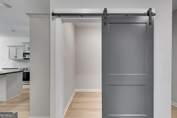 a view of walk in closet with empty racks