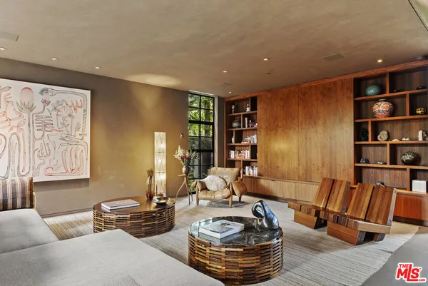 a living room with furniture and a book shelf