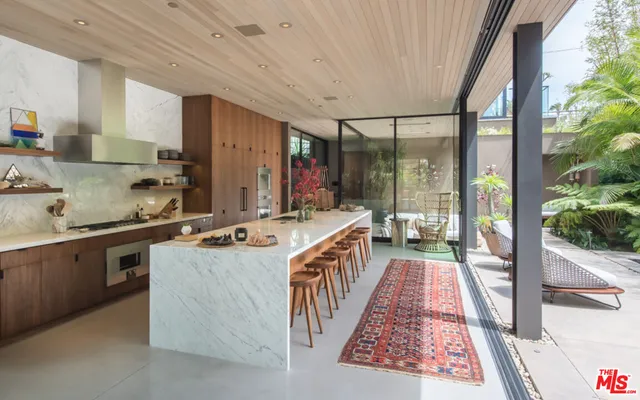 a kitchen with sink a stove and cabinets