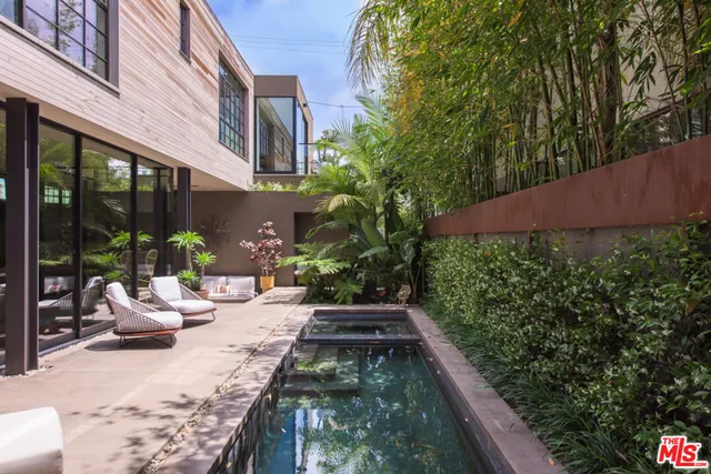 a view of a chair and tables in the patio of the house