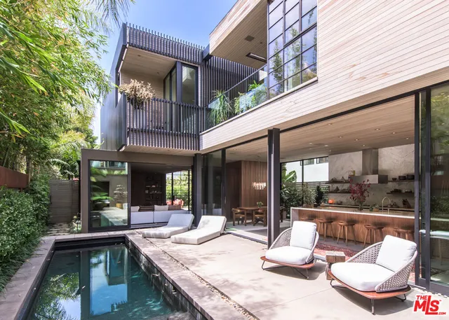 a view of a patio with a table and chairs and potted plants