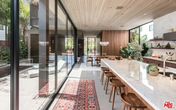 a large hall with dining table and chairs