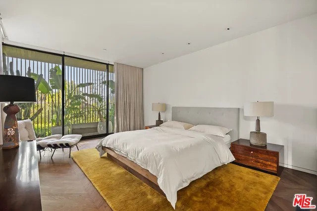 a living room with furniture and a floor to ceiling window