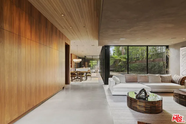 a living room with furniture and a floor to ceiling window