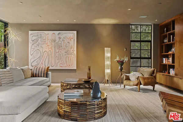 a living room with furniture and a book shelf