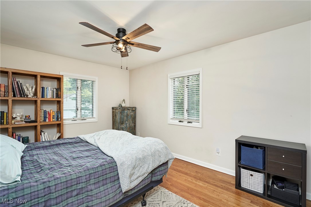 2530 Holgate Road Akron, OH 44313 - Photo 19 of 31 Bedroom featuring multiple windows, wood finished floors, baseboards, and a ceiling fan