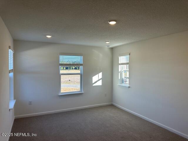 156 Camphor Laurel Road St. Augustine, FL 32092 - Photo 21 of 34 an empty room with windows and mirror