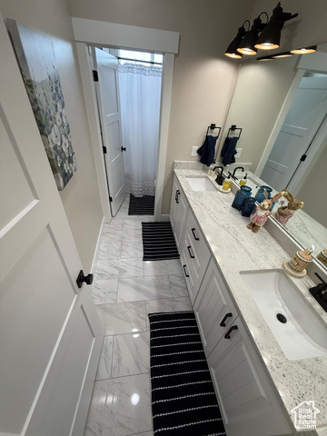 1240 West 2360 North Helper, UT 84526 - Photo 64 of 79 Bathroom featuring baseboards, marble finish floor, a sink, and double vanity