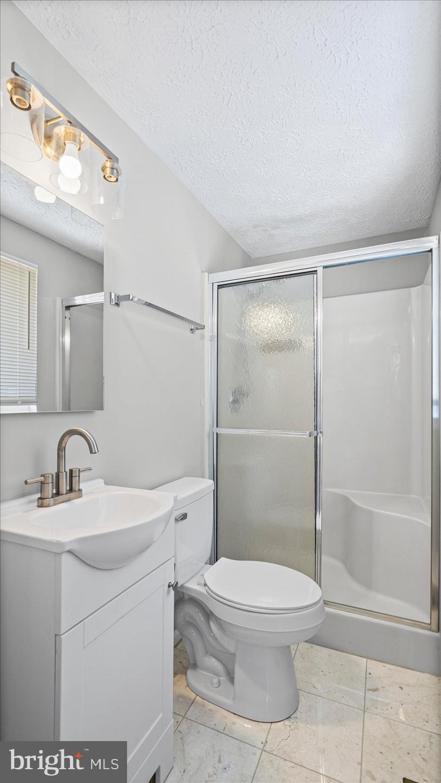 3709 Redberry Way Nottingham, MD 21236 - Photo 27 of 45 a bathroom with a toilet a sink and shower