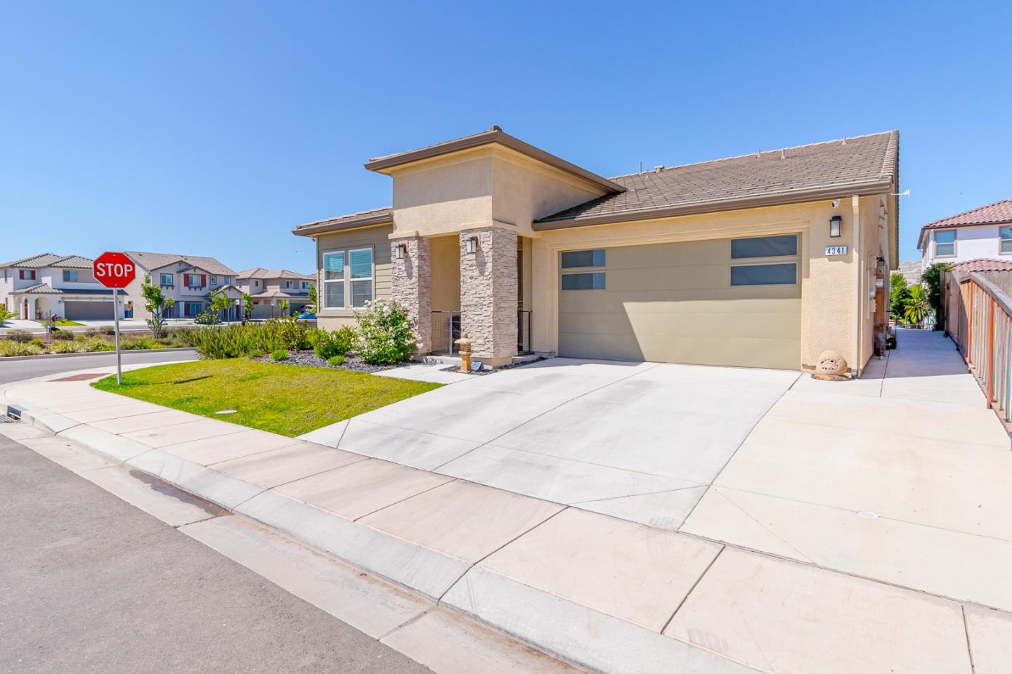 4341 Trailblazer Way Modesto, CA 95356 - Photo 2 of 27 a front view of a house with a yard and garage