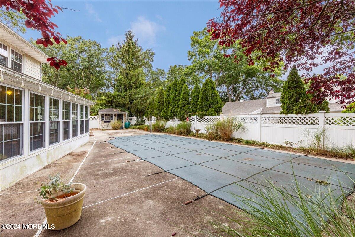 106 Forest Road Brick, NJ 08724 - Photo 18 of 23 a view of a backyard that has plants and trees with wooden fence
