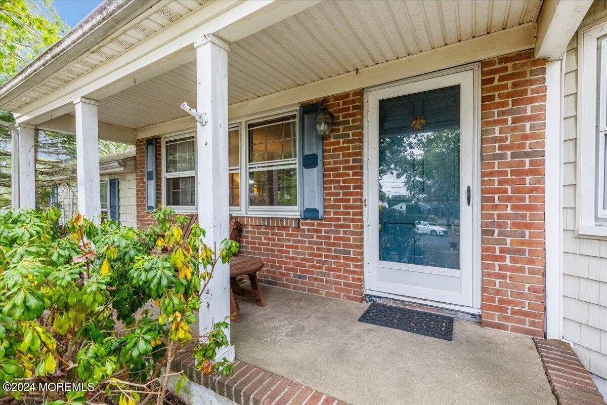 106 Forest Road Brick, NJ 08724 - Photo 3 of 23 a view of a brick house with potted plants