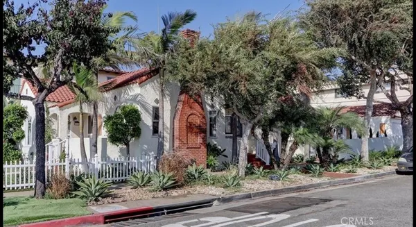 front view of a house with a tree