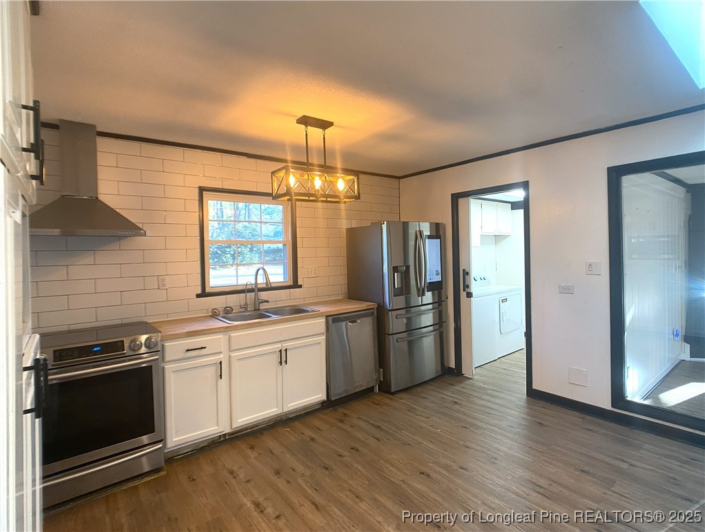 2405 Morganton Road Fayetteville, NC 28303 - Photo 14 of 46 a kitchen with stainless steel appliances a stove a refrigerator and a sink