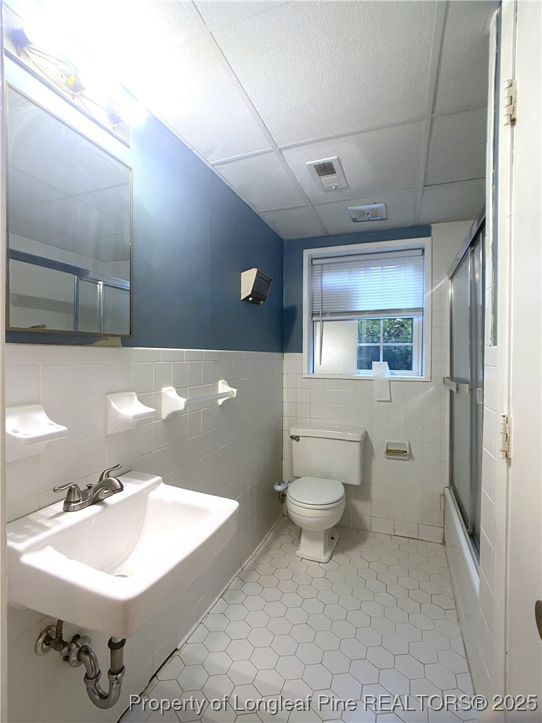 2405 Morganton Road Fayetteville, NC 28303 - Photo 36 of 46 a bathroom with a sink a toilet and mirror