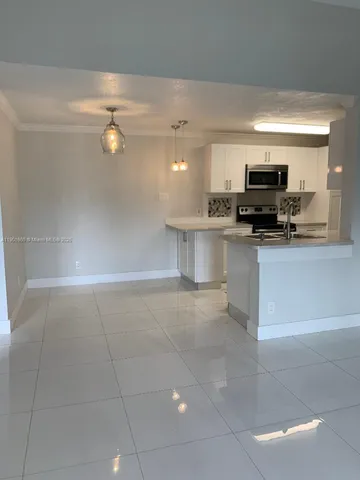 a kitchen with a sink and a stove top oven
