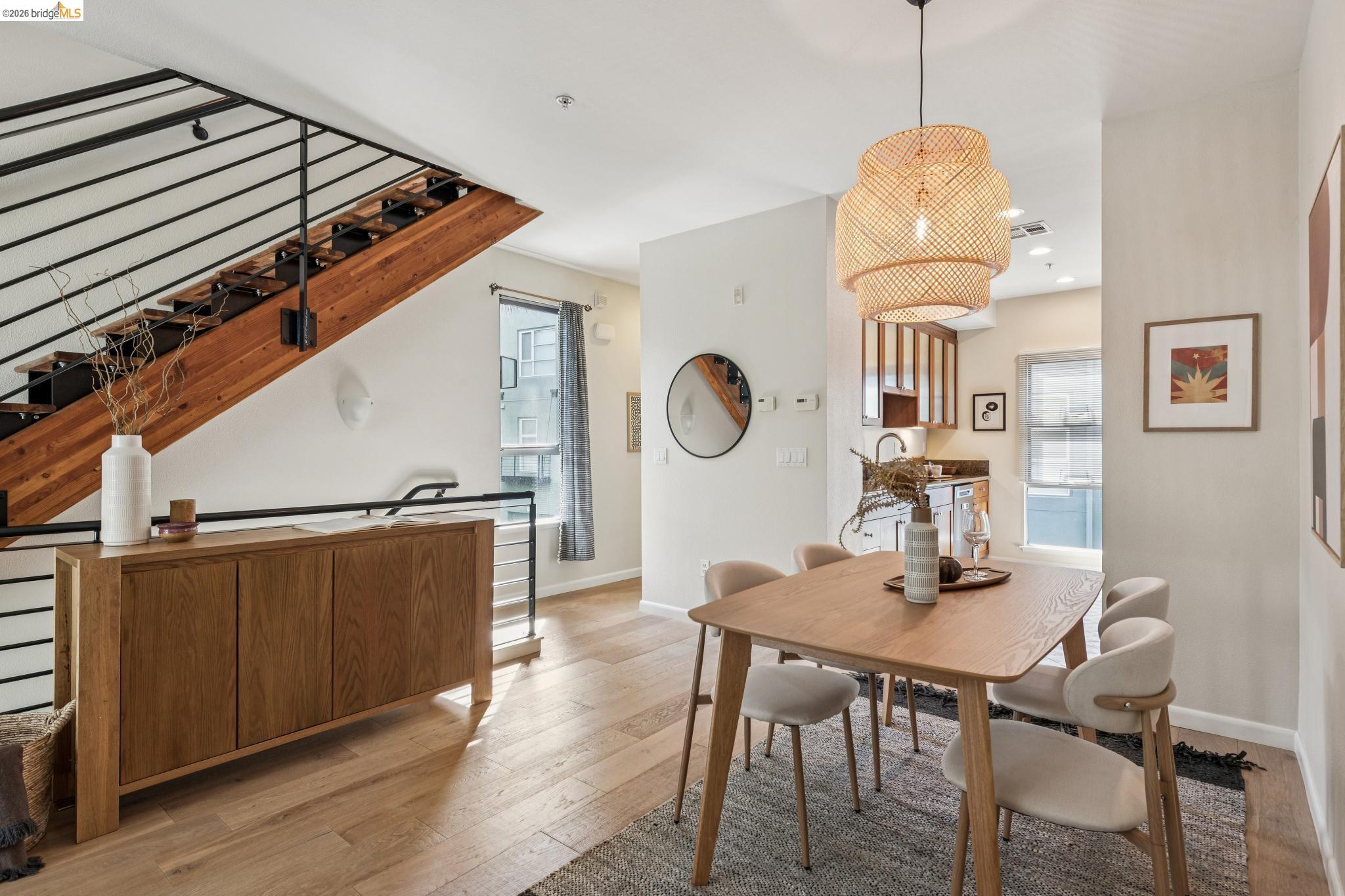 61 Glashaus Loop Emeryville, CA 94608 - Photo 11 of 39 a dining room with wooden floor a chandelier a wooden table and chairs