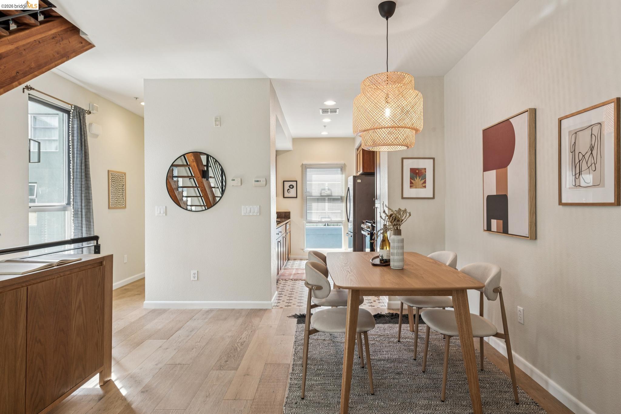 61 Glashaus Loop Emeryville, CA 94608 - Photo 12 of 39 a dining room with wooden floor and a chandelier