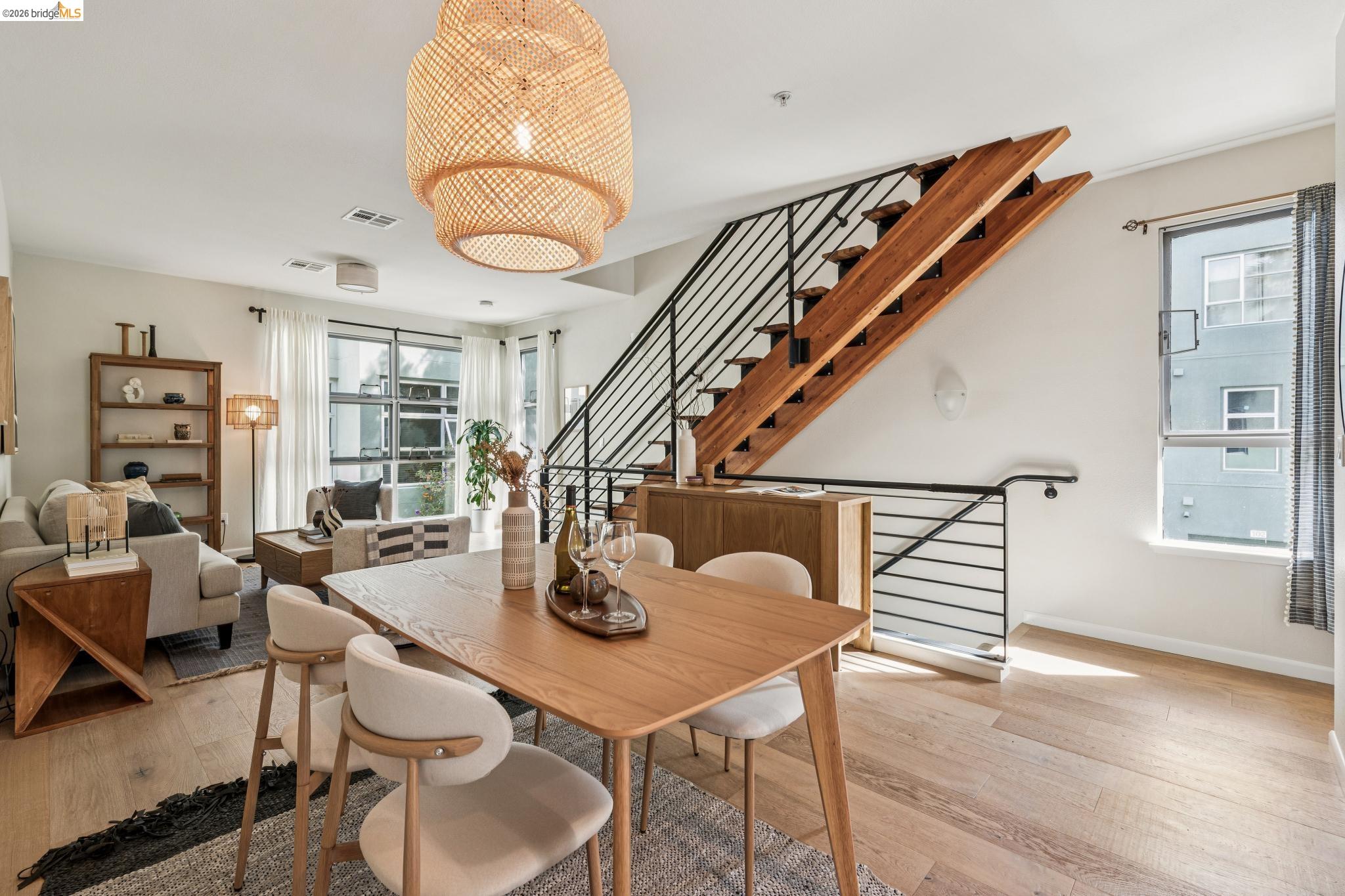 61 Glashaus Loop Emeryville, CA 94608 - Photo 13 of 39 a dining room with wooden floor a glass table and chairs