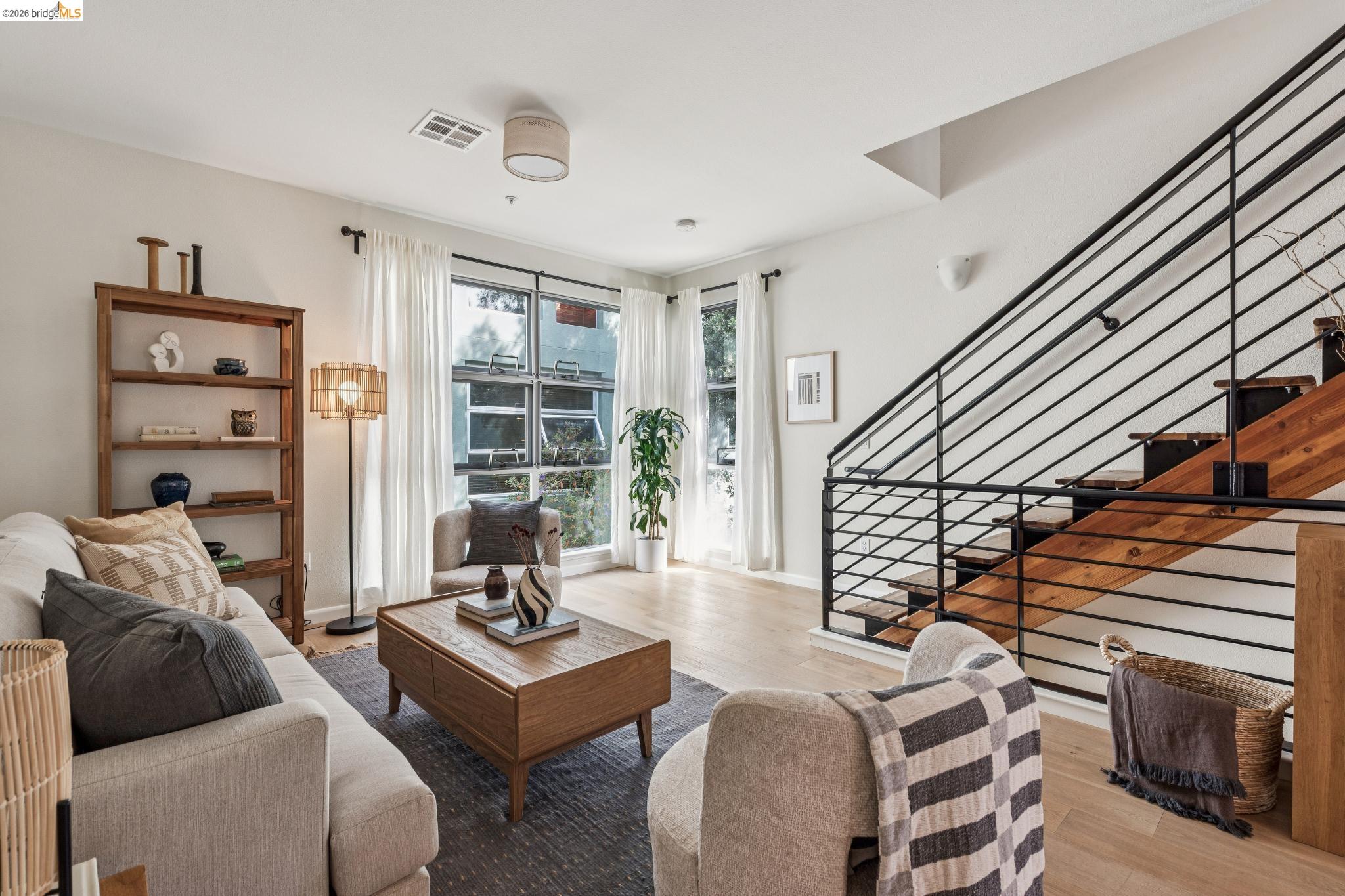 61 Glashaus Loop Emeryville, CA 94608 - Photo 2 of 39 a living room with furniture and a floor to ceiling window