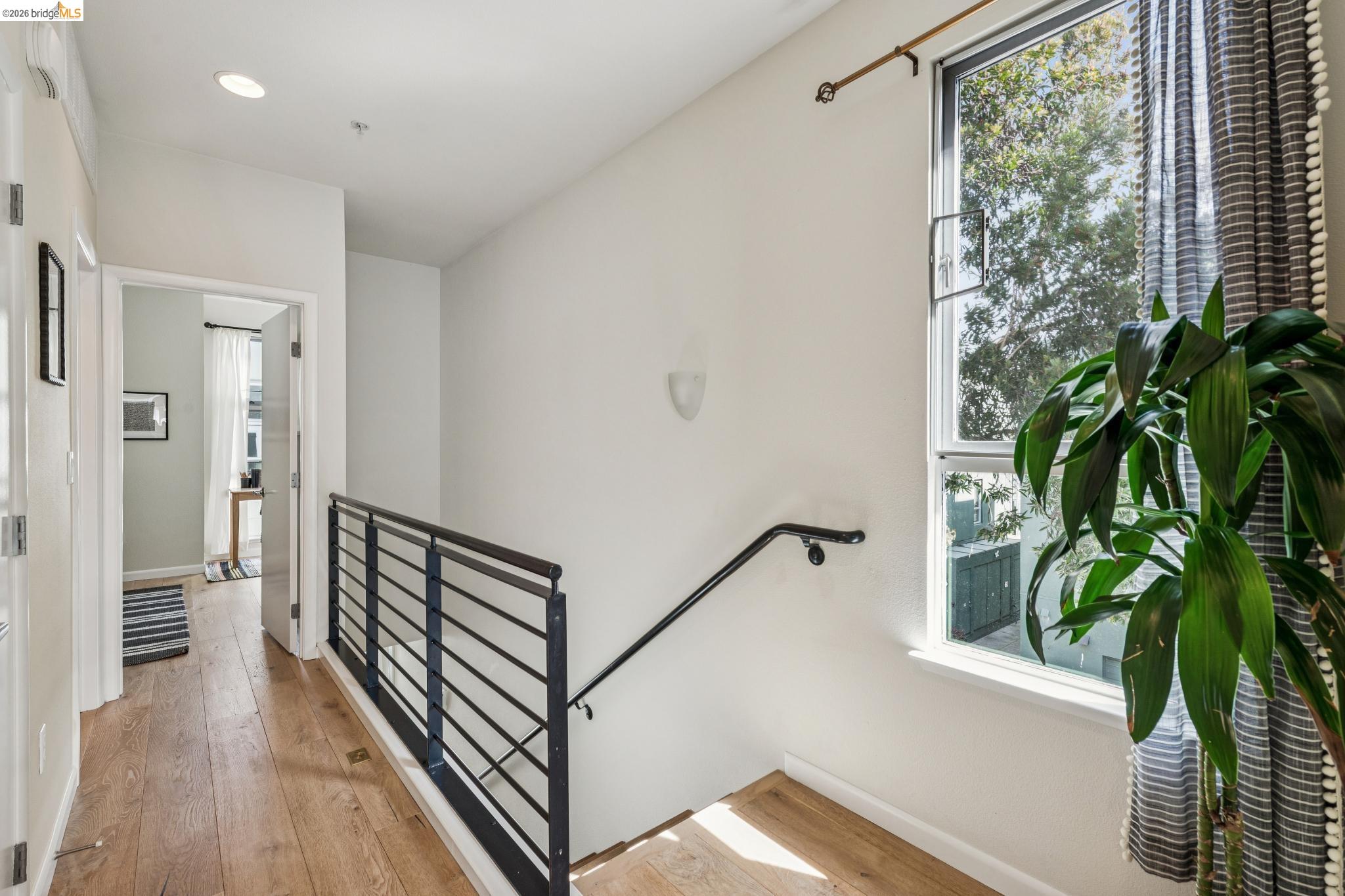 61 Glashaus Loop Emeryville, CA 94608 - Photo 22 of 39 a view of hallway with stairs and wooden floor