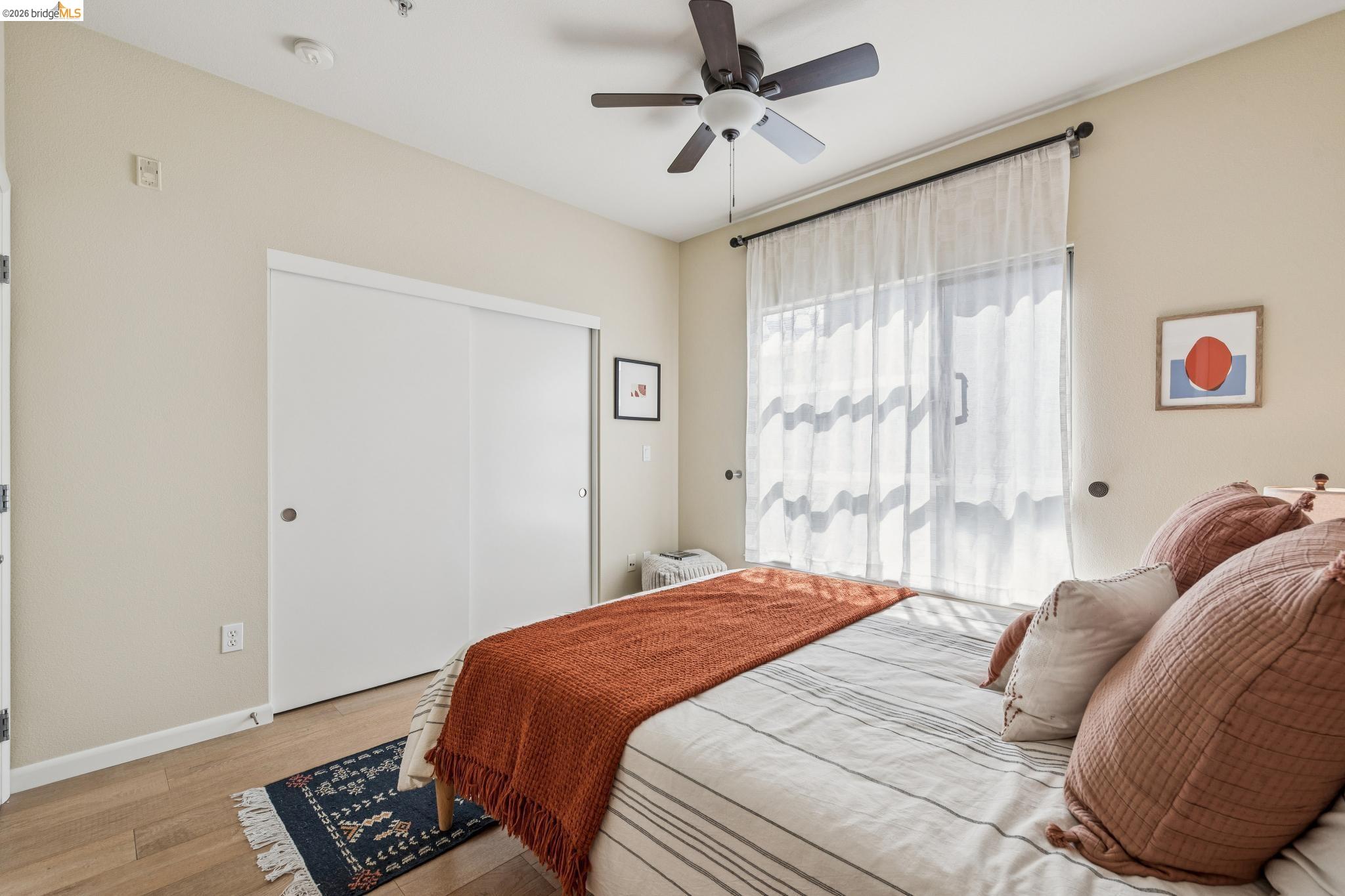 61 Glashaus Loop Emeryville, CA 94608 - Photo 23 of 39 a bedroom with a bed and a window with a bookshelf