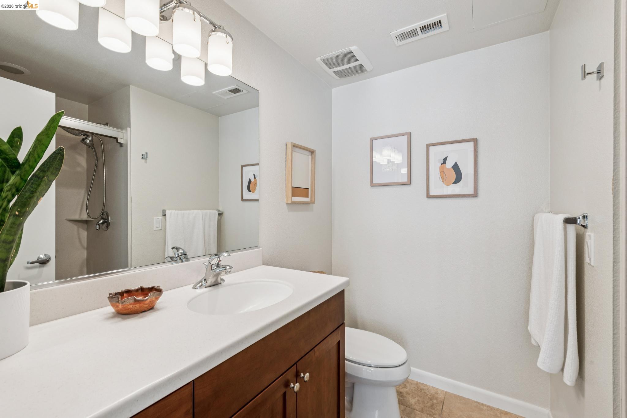 61 Glashaus Loop Emeryville, CA 94608 - Photo 26 of 39 a bathroom with a sink a toilet and a large mirror