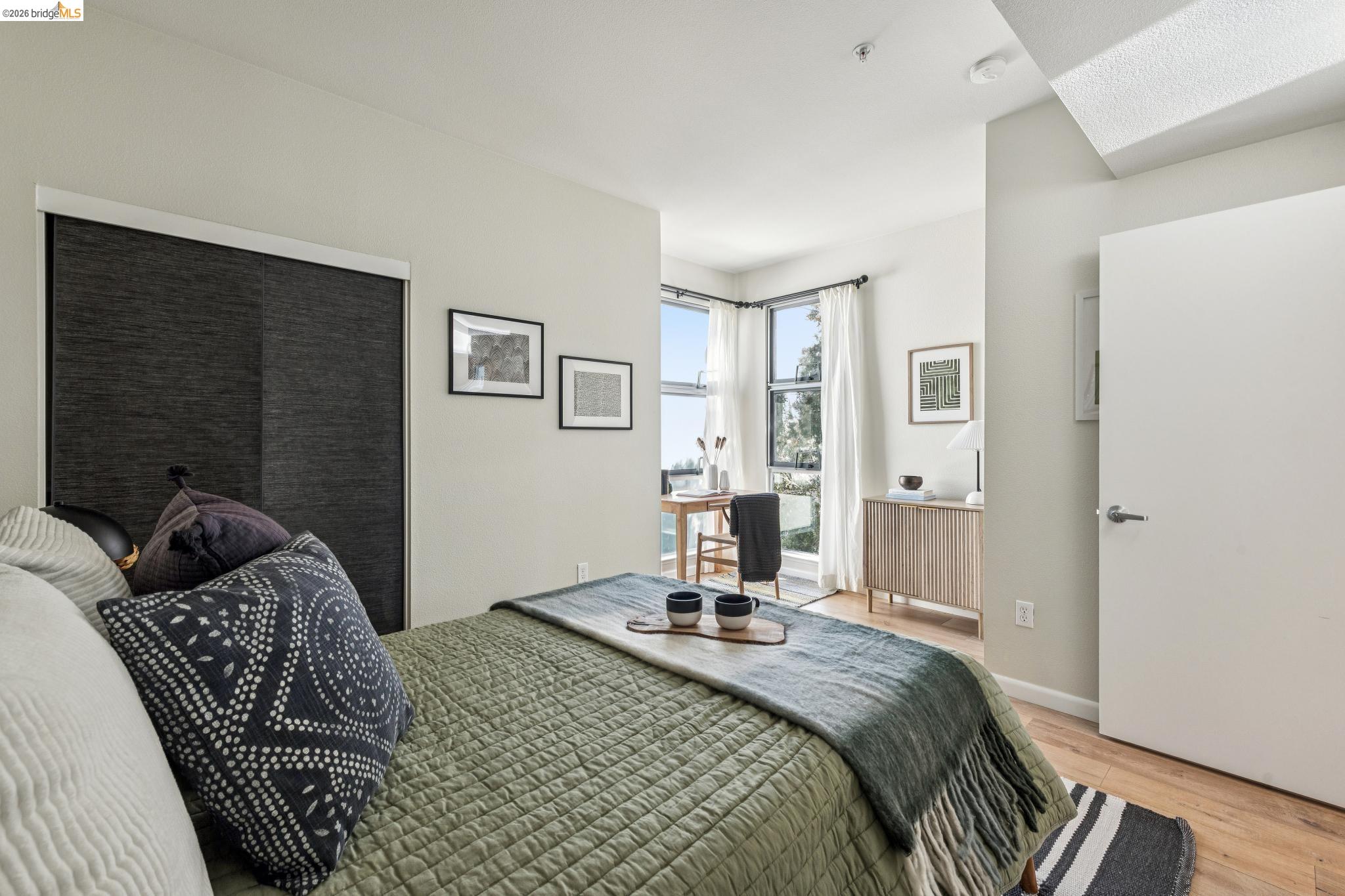 61 Glashaus Loop Emeryville, CA 94608 - Photo 27 of 39 a bedroom with a bed and wooden floor