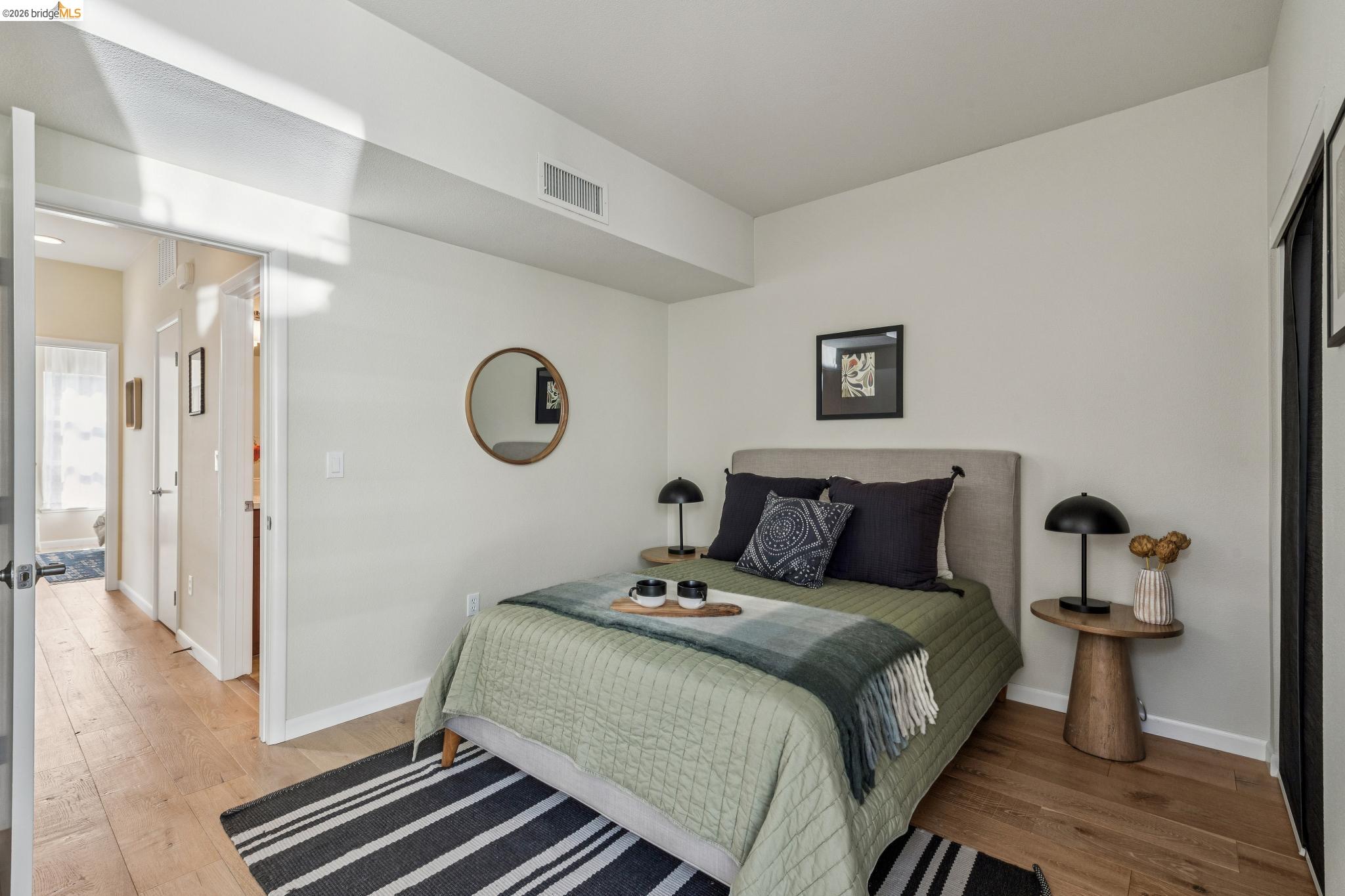 61 Glashaus Loop Emeryville, CA 94608 - Photo 31 of 39 a bedroom with a bed and wooden floor