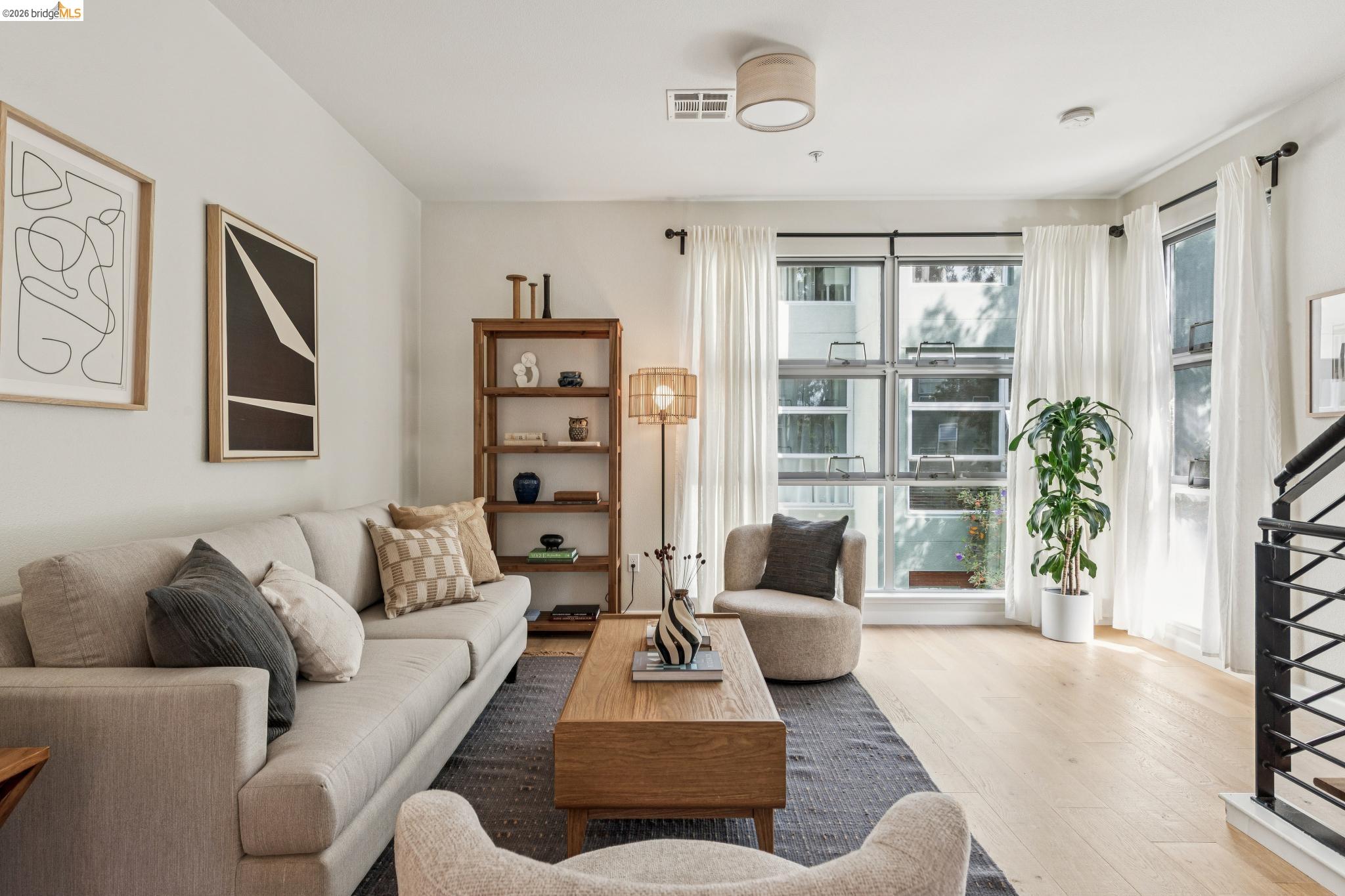 61 Glashaus Loop Emeryville, CA 94608 - Photo 4 of 39 a living room with furniture and a large window