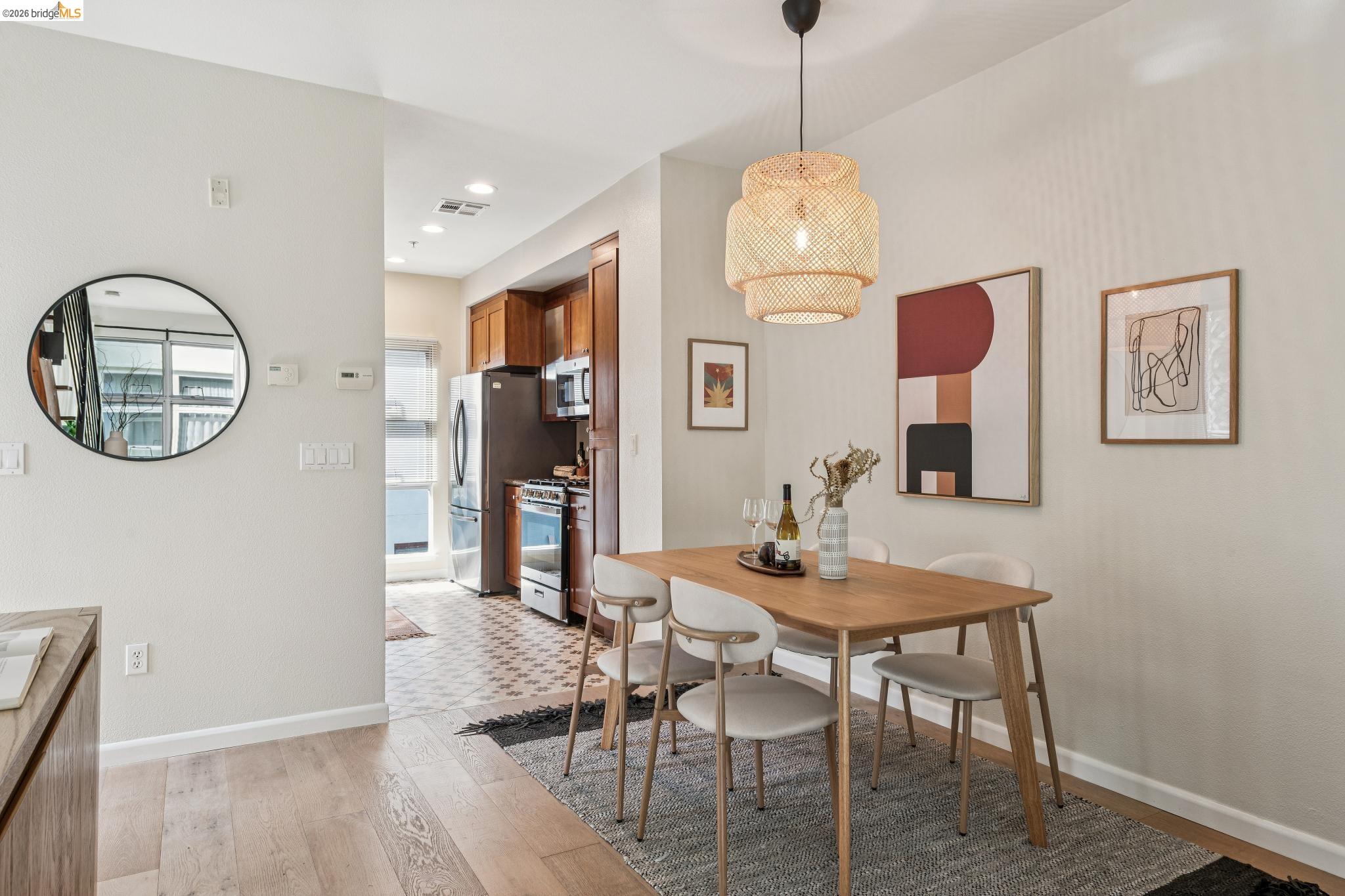 61 Glashaus Loop Emeryville, CA 94608 - Photo 10 of 39 a dining room with wooden floor a chandelier a wooden table and chairs
