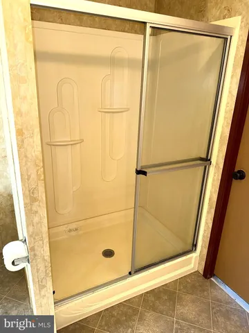 a bathroom with a shower and a sink