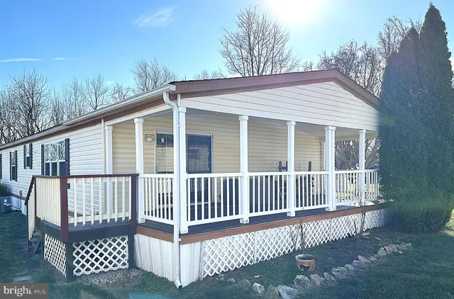 a view of a wooden deck and a yard
