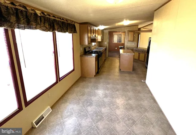 a view of a refrigerator and window in a room
