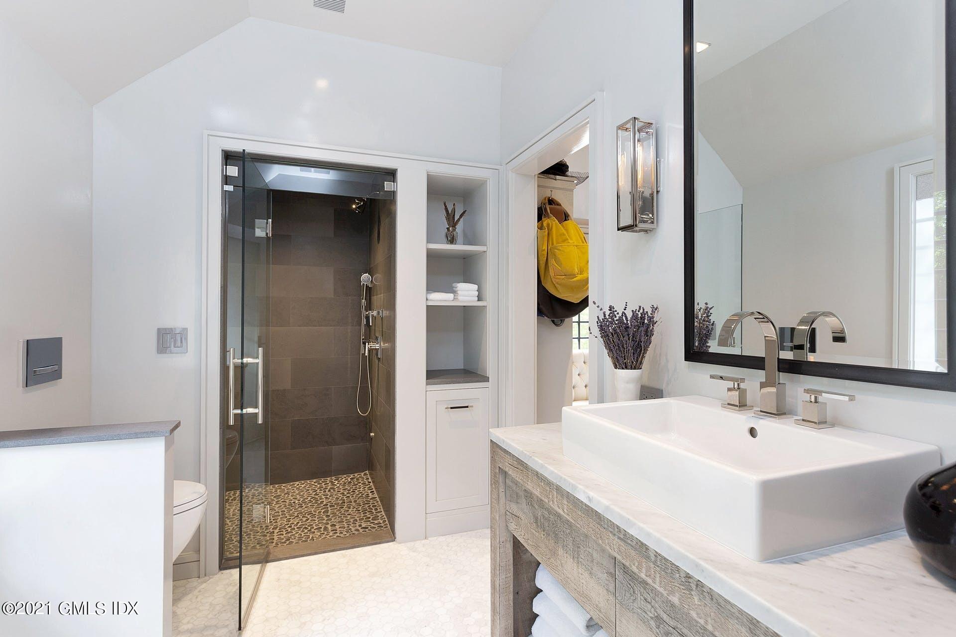 54 Pecksland Road Greenwich, CT 06831 - Photo 28 of 40 a bathroom with a sink and a mirror