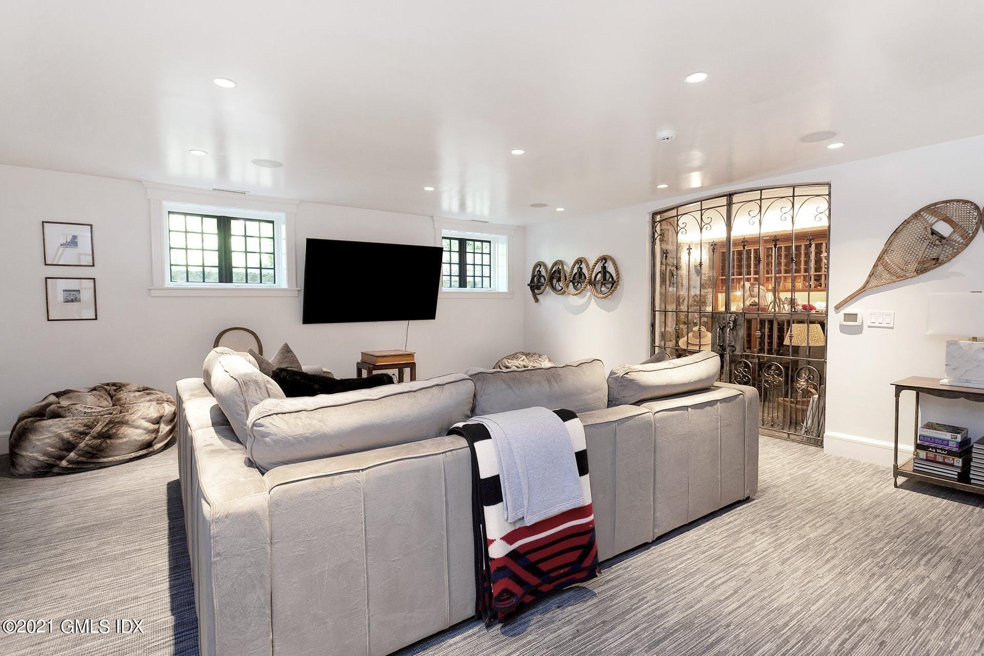 54 Pecksland Road Greenwich, CT 06831 - Photo 32 of 40 a living room with furniture and a flat screen tv
