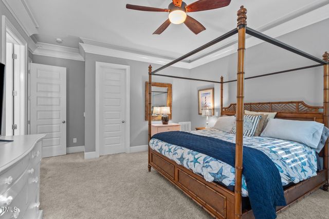 a bedroom with a large bed and a flat screen tv